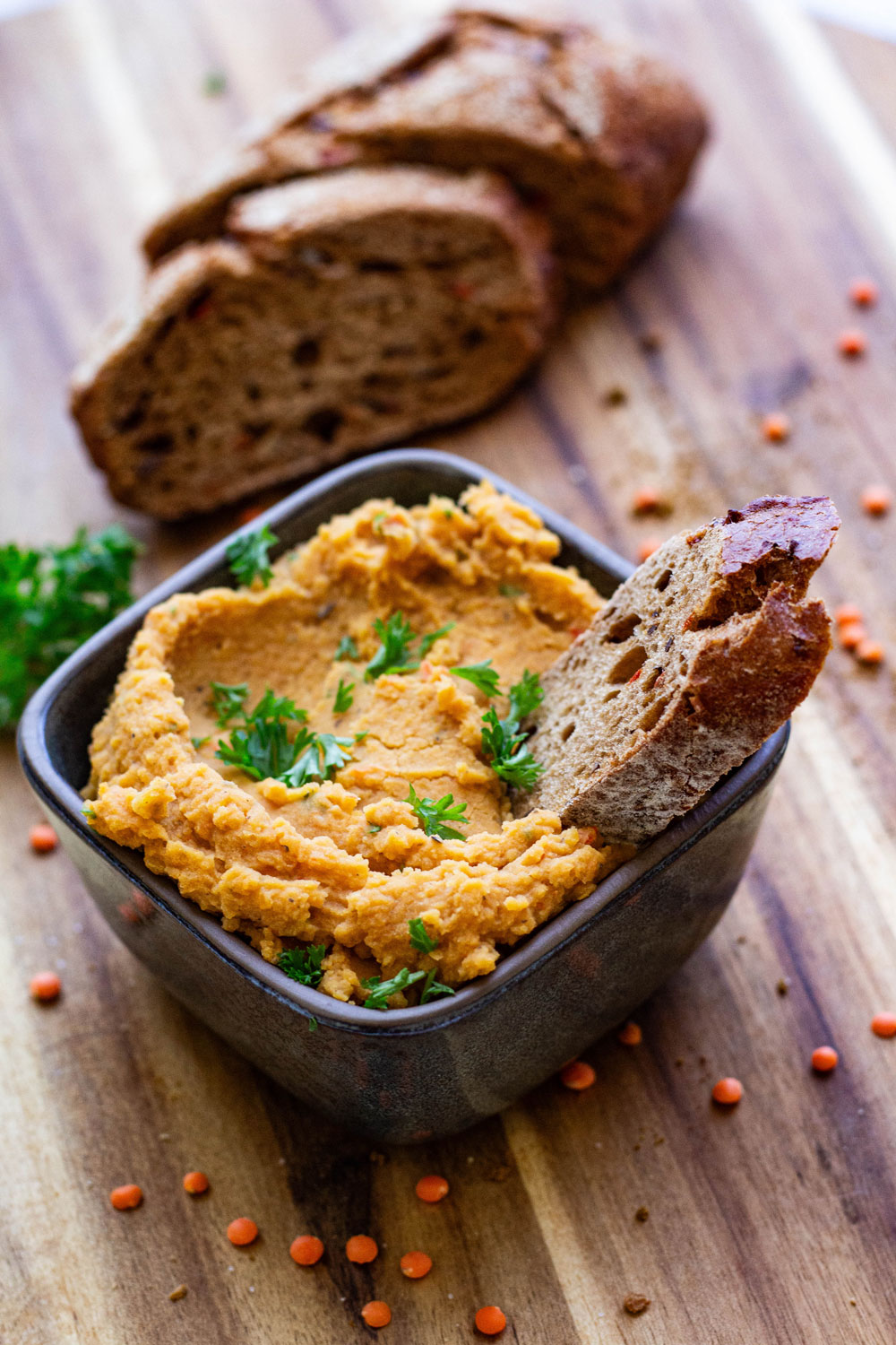 Linsenaufstrich in Schale mit Brotscheibe