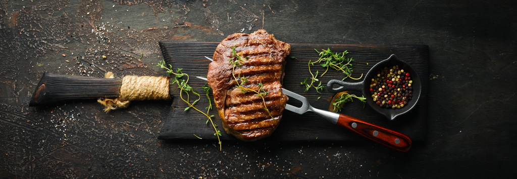 Gegrilltes Ribeye Steak, frische Kräuter und verschiedenen Pfefferkörnern