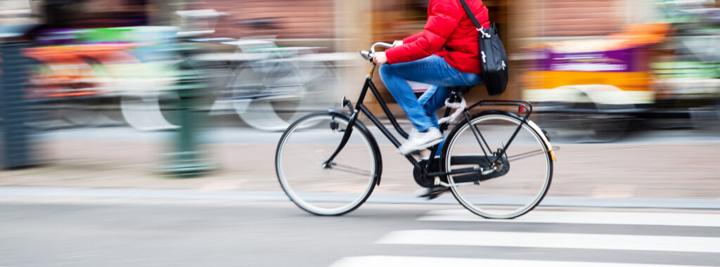 Mensch fährt Fahrrad auf einer Straße